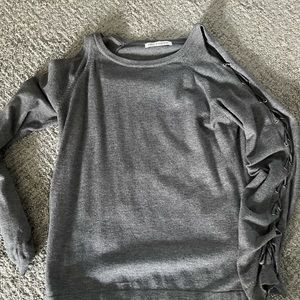 Soft grey cold shoulder sweater with tied sleeves.